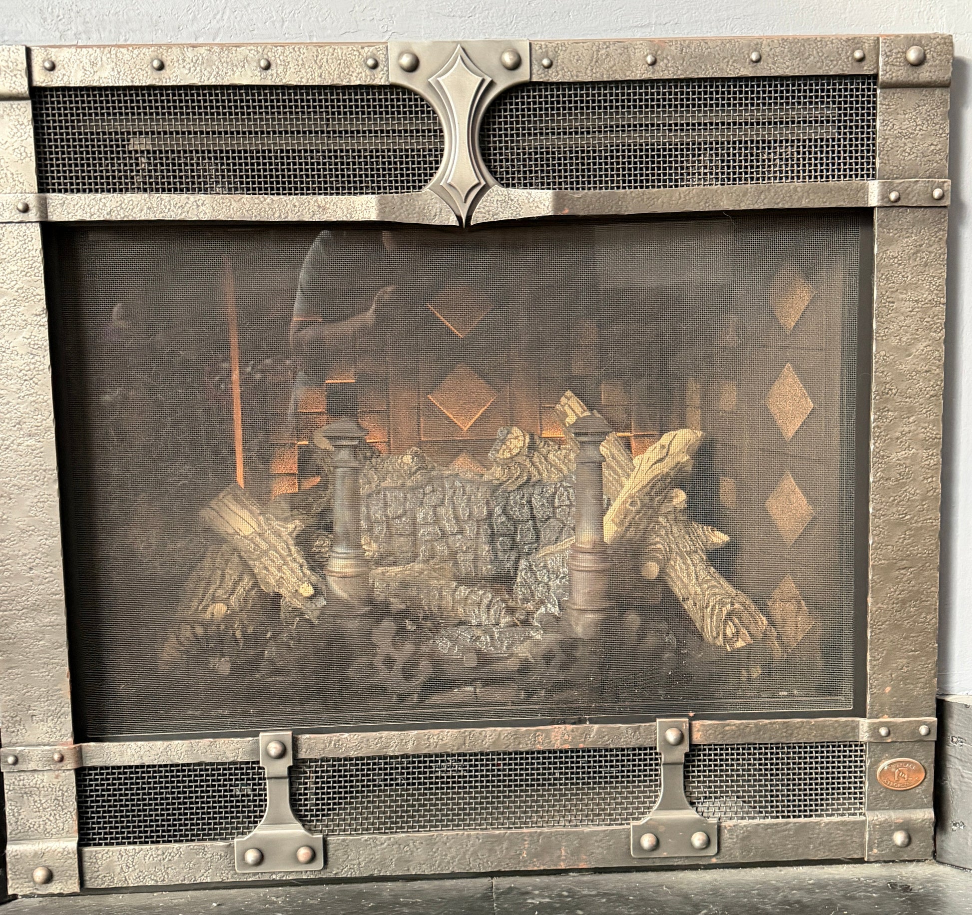 Fireplace with decorative screen and fire inside