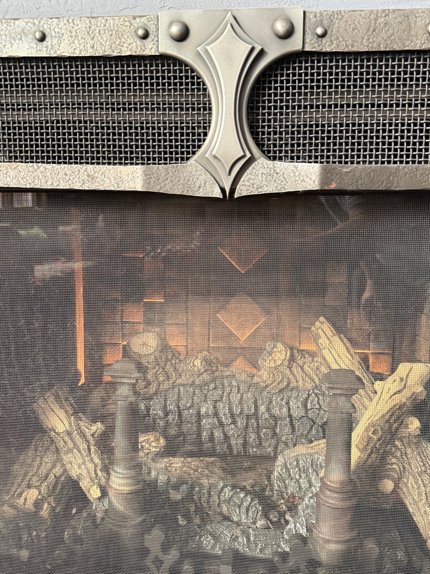 Close-up of a metal screen with textured background