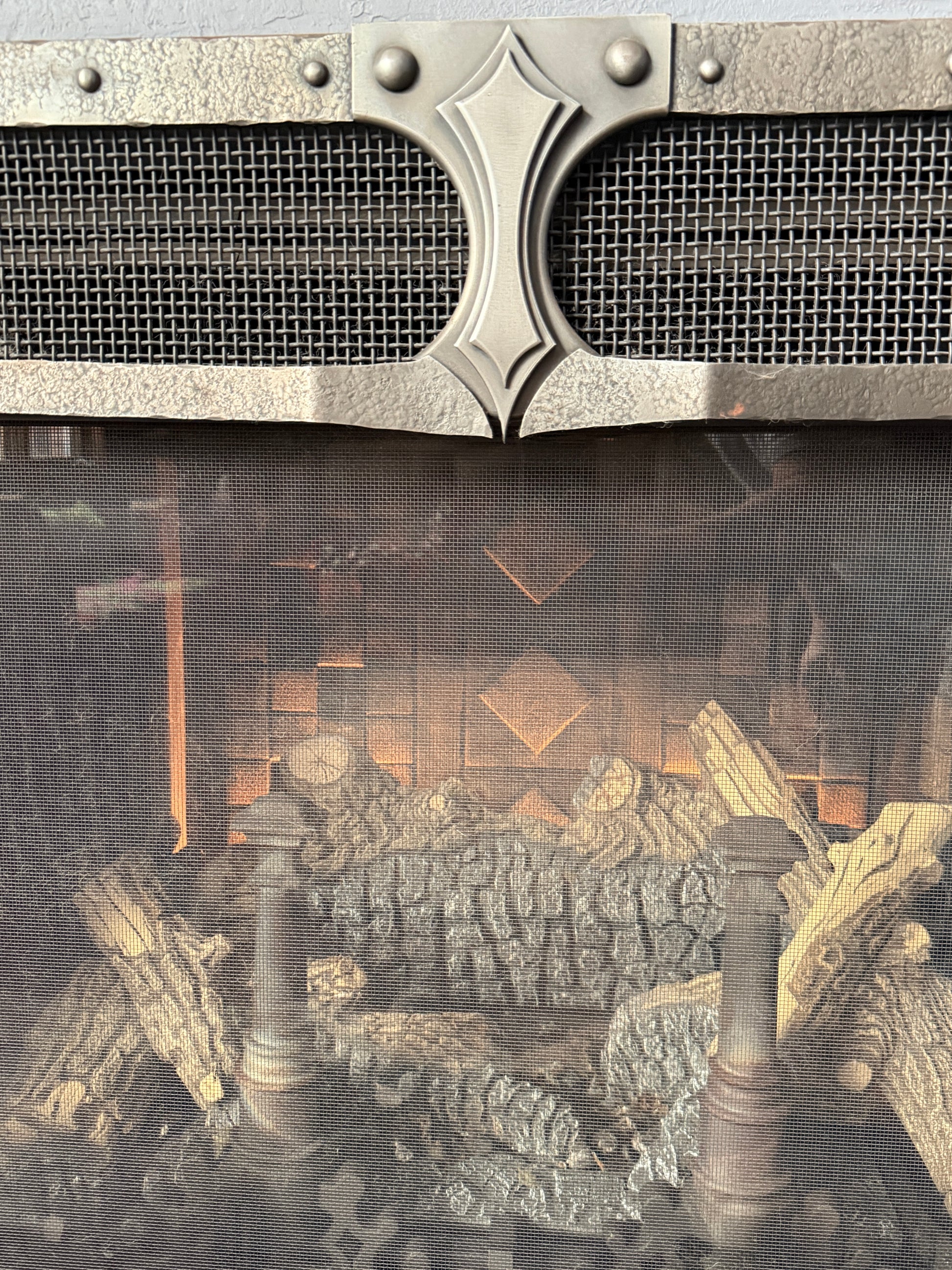 Close-up of a metal screen with textured background