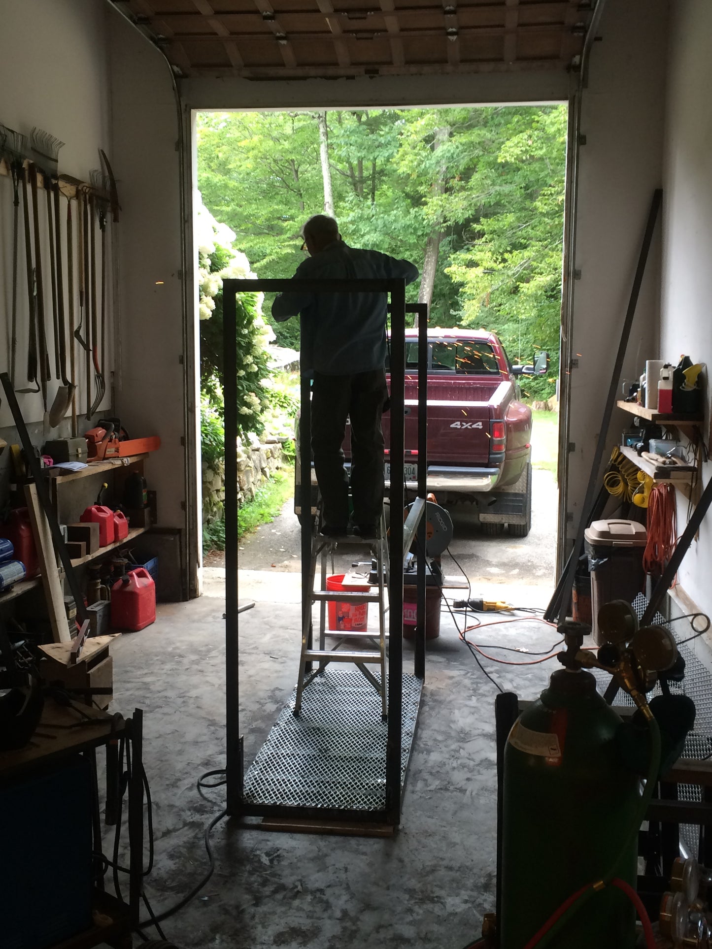 Person working in a garage with tools and equipment around