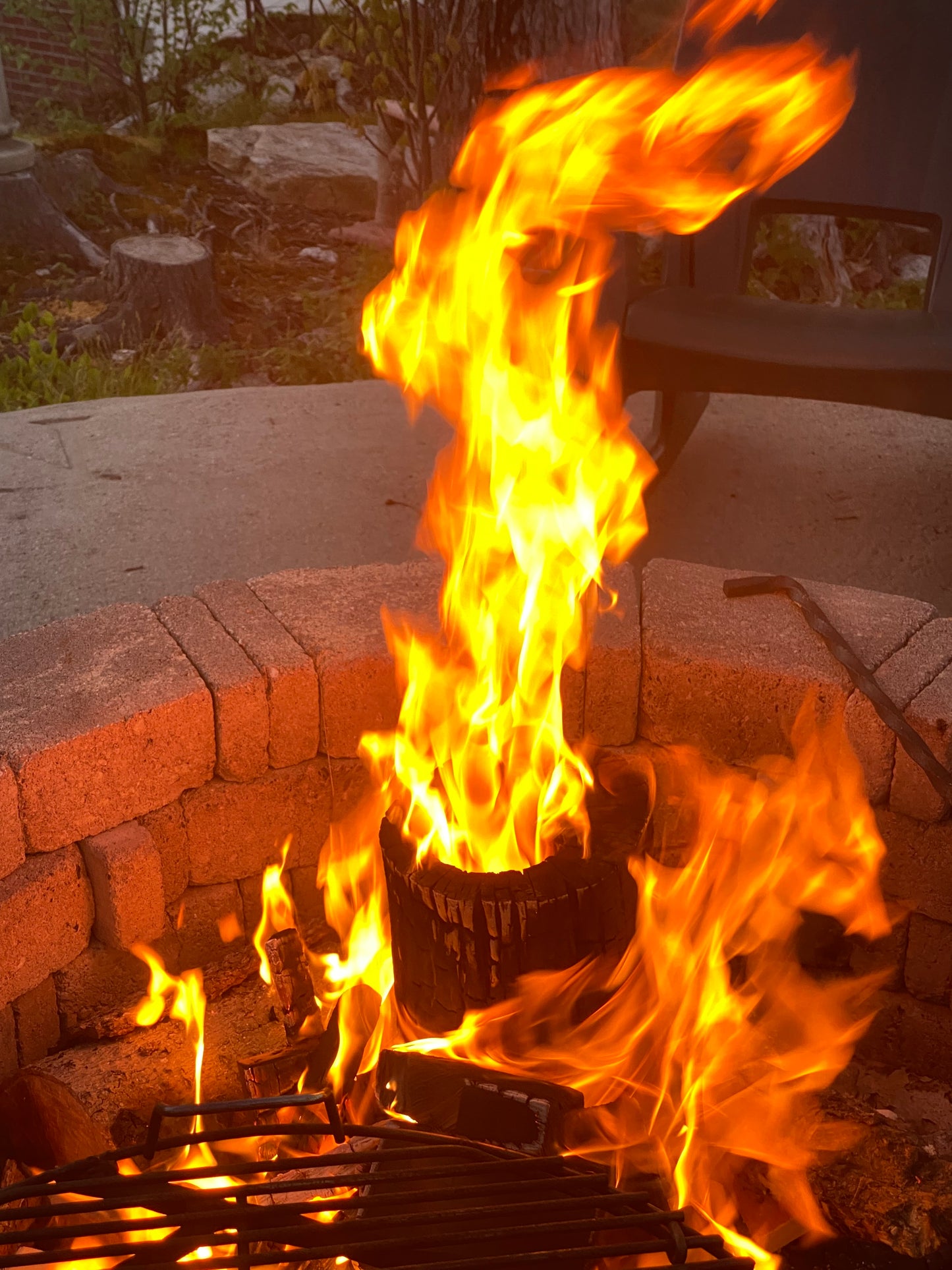 Flames burning on a brick structure with a blurred background