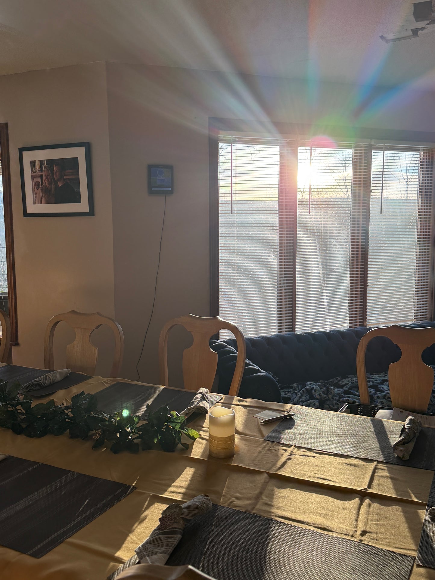 dining room  room with a couch, coffee table, and sun shining through the window.