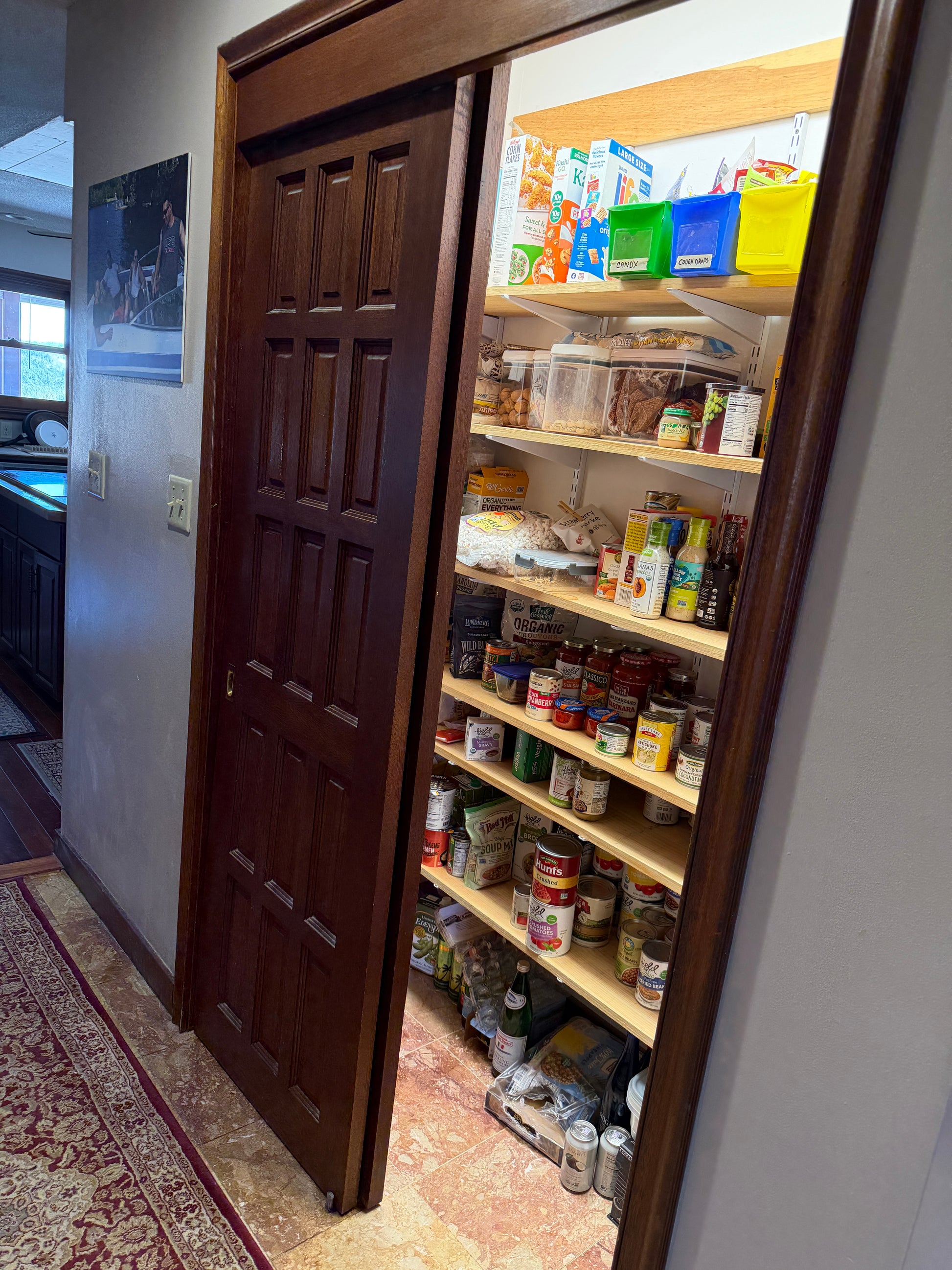 Open pantry with shelves stocked with food items