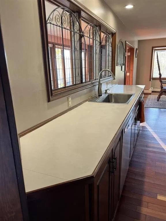 Kitchen counter with sink and decorative window in a home interior