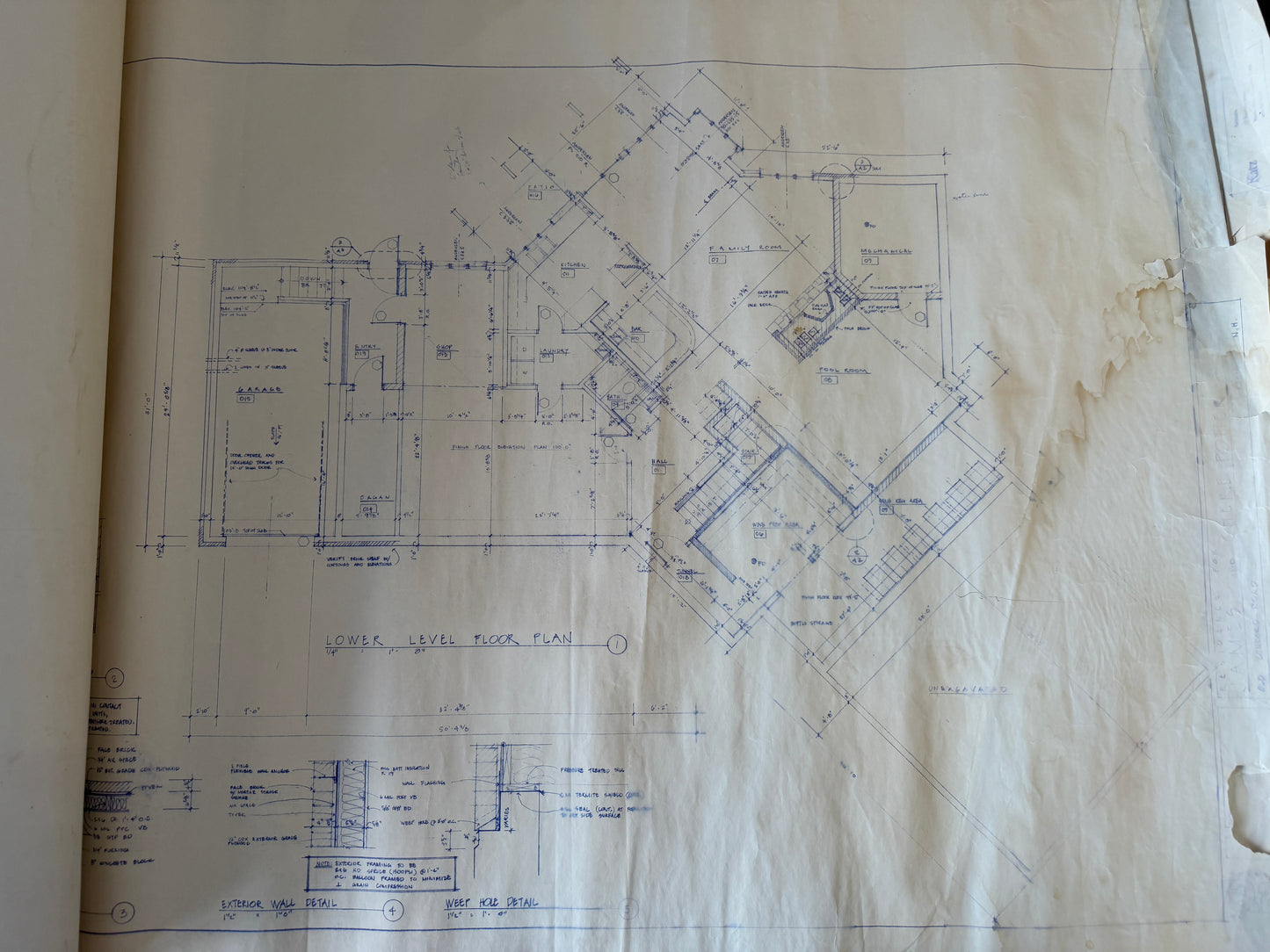 Blueprints on a piece of paper with visible wear and tear.