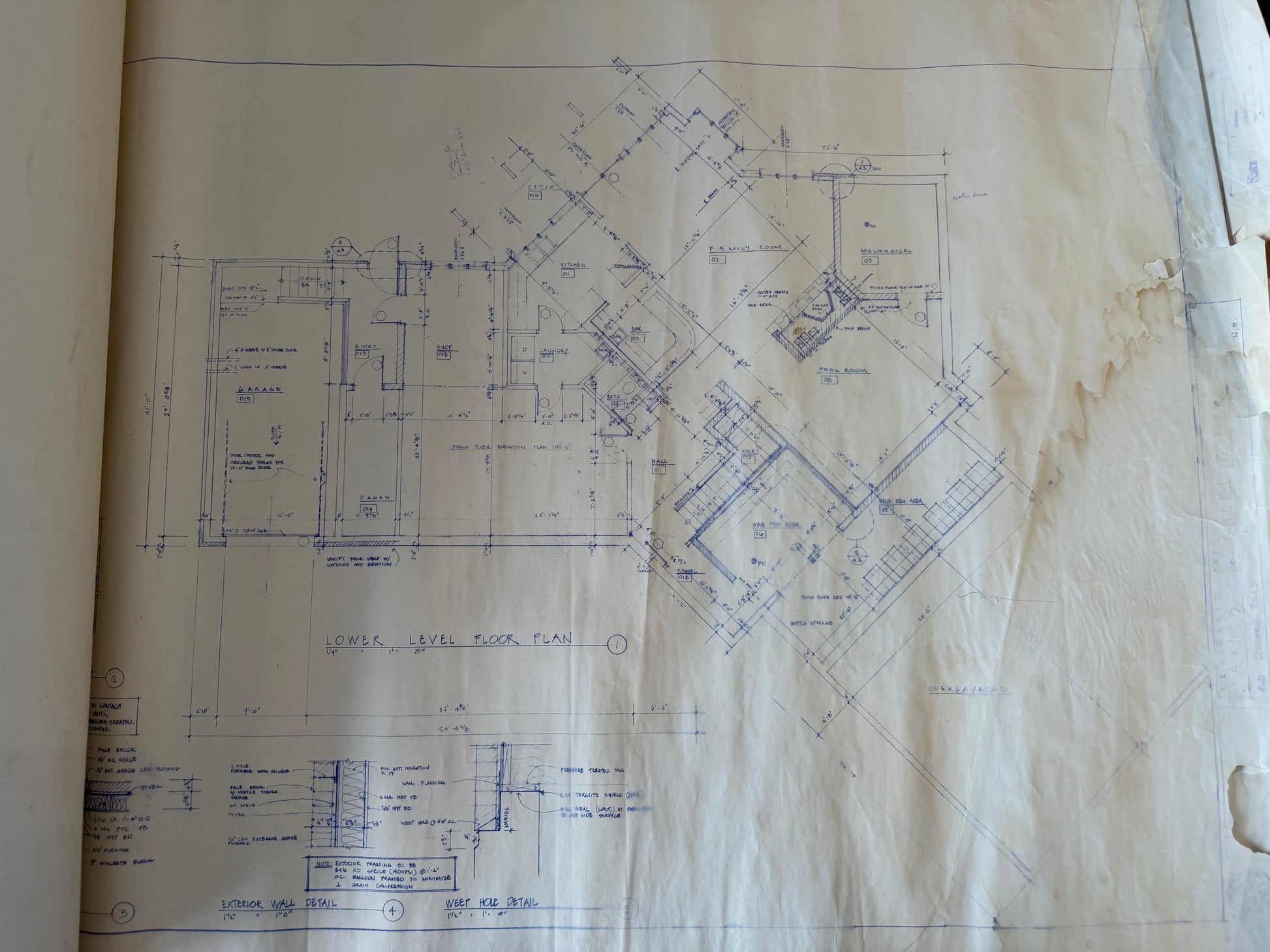 Blueprints on a piece of paper with visible wear and tear.