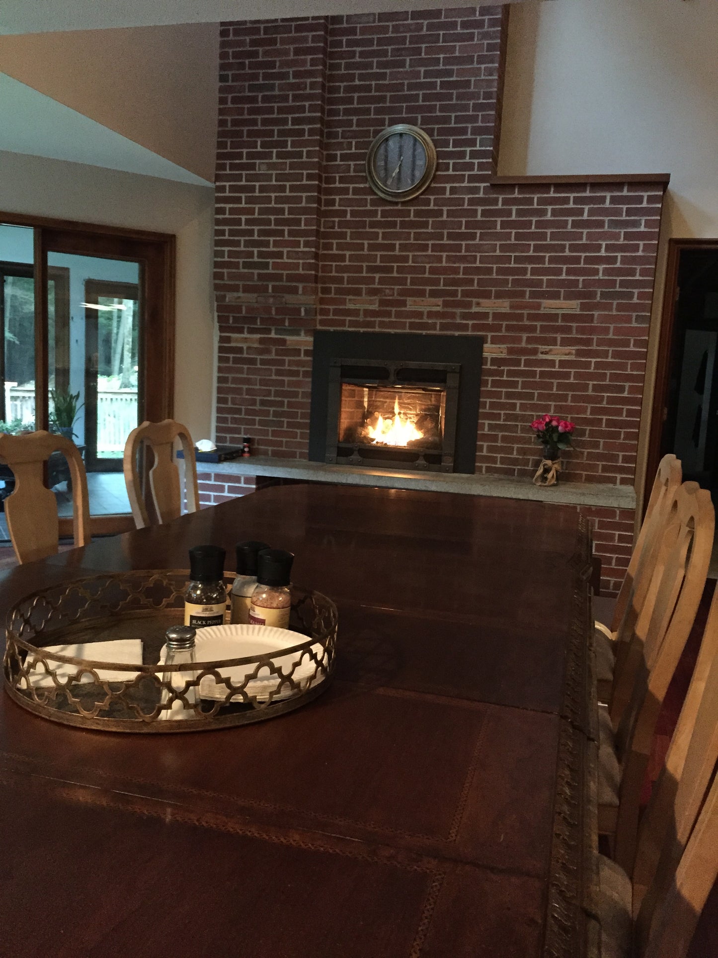 Living room with a brick wall, fireplace, and decorative items.