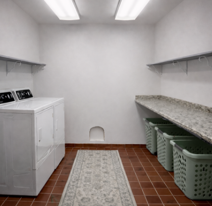Laundry room with washing machine, dryer, and laundry baskets on a tiled floor. Very bright room