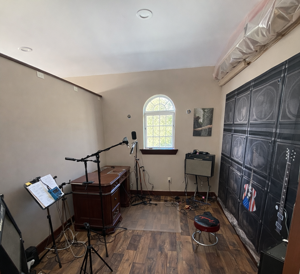Music practice room with musical instruments and equipment.