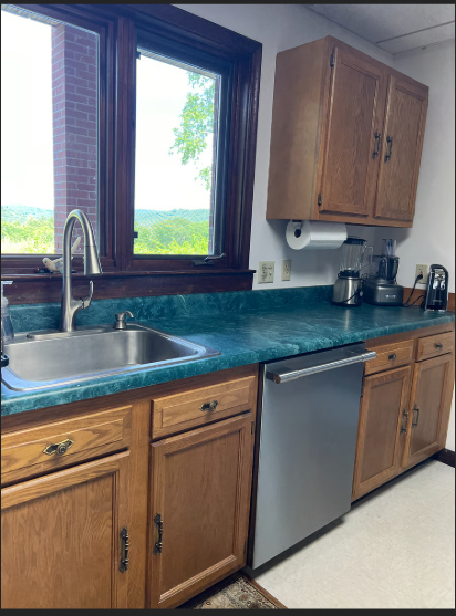 Kitchen with wooden cabinets, stainless steel sink, and dishwasher.
