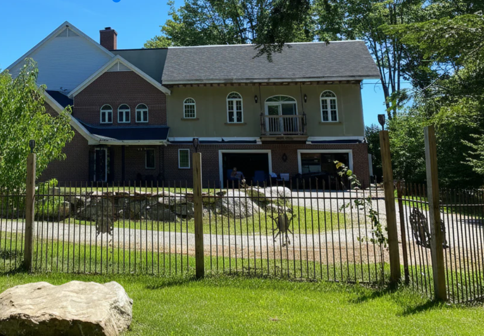 Nature View Estate  Keene NH. Real Estate For Sale. Large house  wrought iron fencing with a long driveway and private setting in nature
