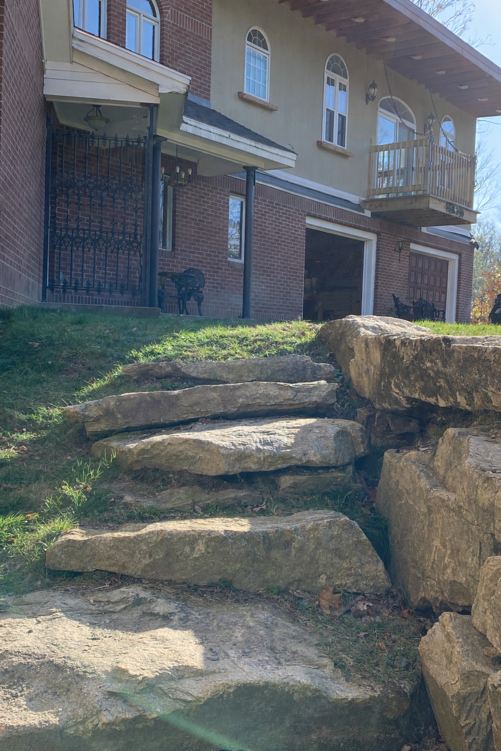 Stone steps leading up to a house with a brick exterior