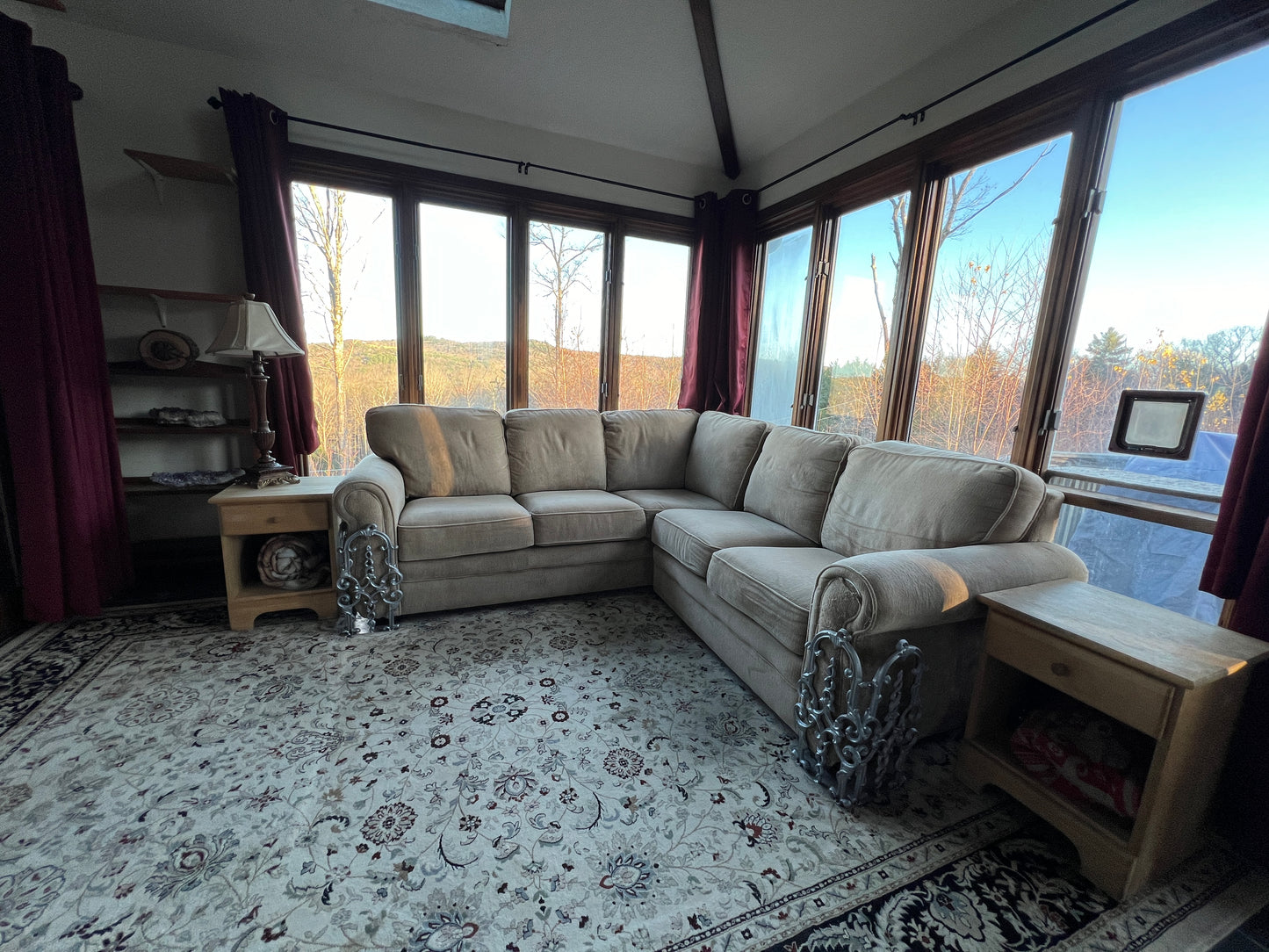 Living room with a sectional sofa, rug, and large windows.